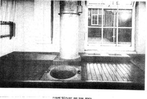 A black and white photo of a toilet in the middle of a porch.